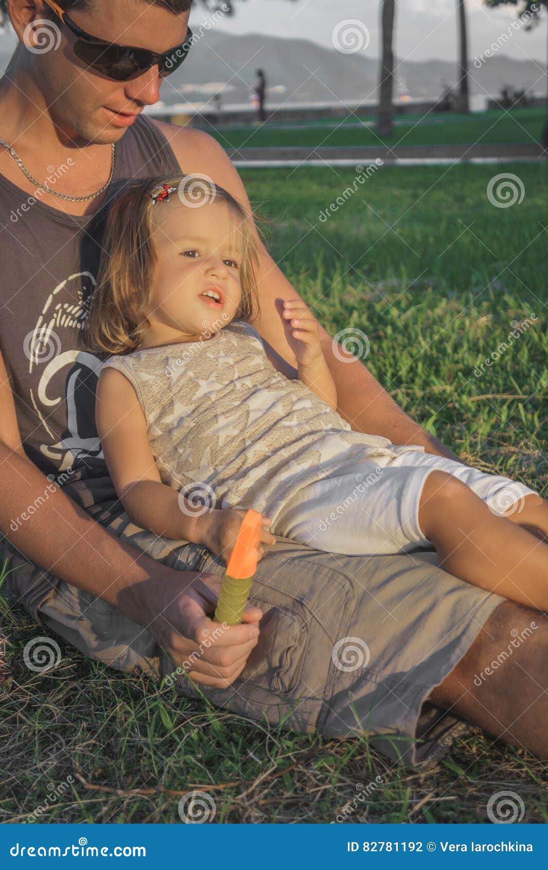 daughter sits on dads lap